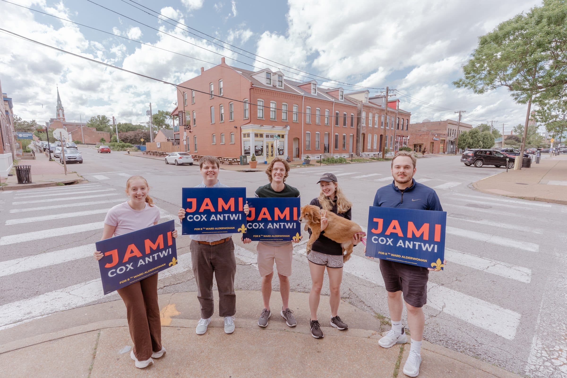 Jami Cox Antwi with supporters holding Jami signs at a neighborhood crosswalk